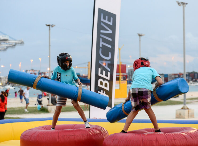 Two children wrestling in Birżebbuga during a Be Active sports event